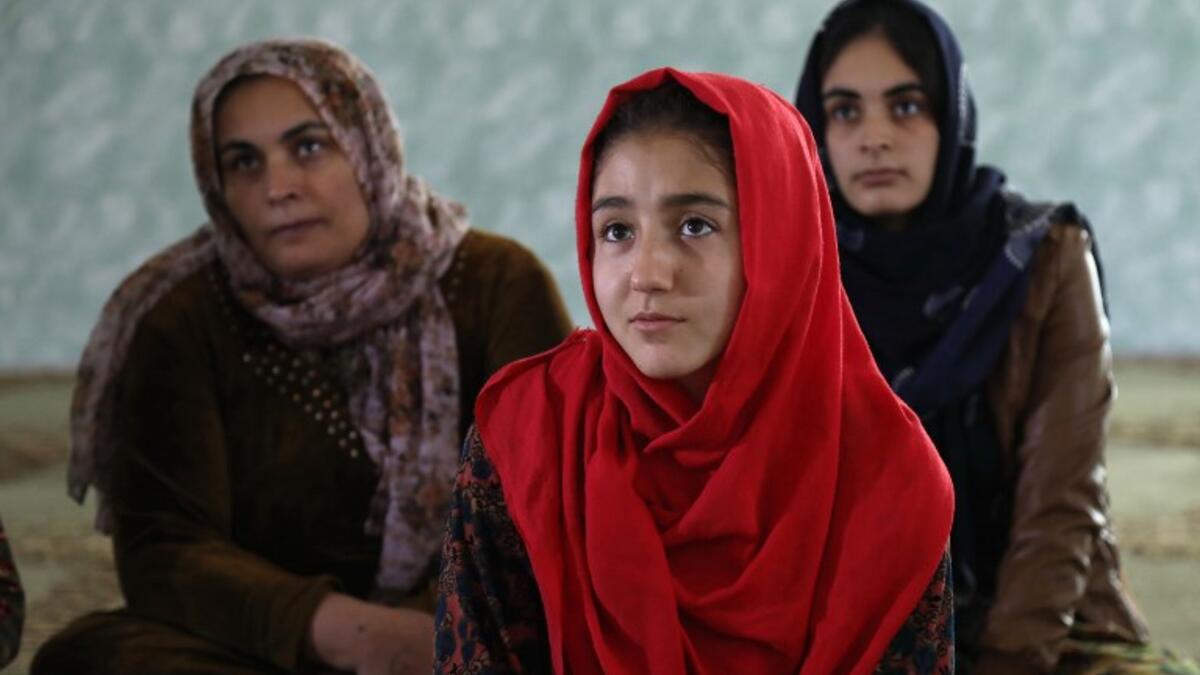 Women and young girls listen to Rasul, an Iraqi Kurdish activist with the non-profit organisation WADI, as she peaks about the harms of genital mutilation in Sharboty Saghira, a small village east of regional capital Arbil.
SAFIN HAMED / AFP