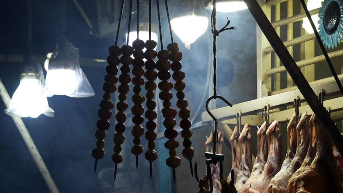 Skewers of lamb hang at a Charsi (Hashish) Tikka restaurant in Namak Mandi in Peshawar.
ABDUL MAJEED / AFP