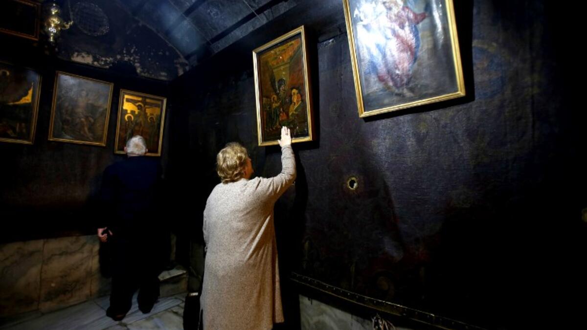 Christian worshippers pray inside the Grotto, believed to be the exact spot where Jesus Christ was born, at the Church of the Nativity in the biblical West Bank city of Bethlehem, on December 22, 2018, three days ahead of the Christmas celebration. Musa Al Shaer/AFP