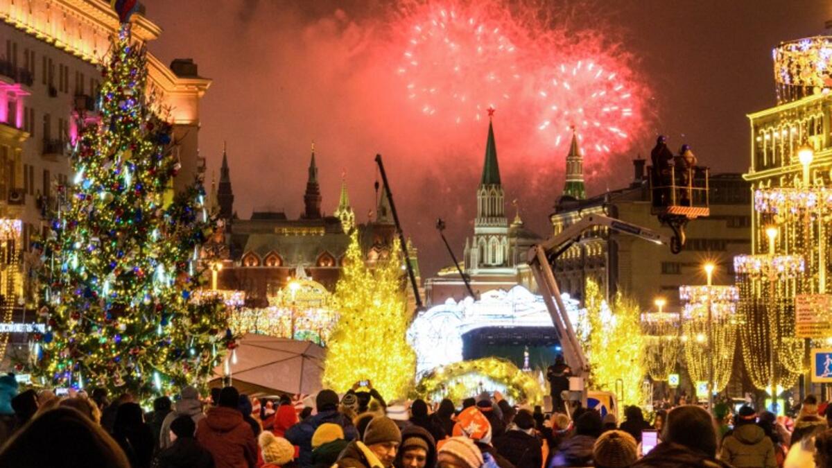People look at fireworks exploding over the Kremlin in Moscow during New Year celebrations, on January 1, 2019. 
Mladen ANTONOV / AFP
