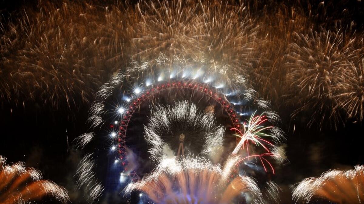 Fireworks explode around the London Eye during New Year's celebrations in central London just after midnight on January 1, 2019. 
ADRIAN DENNIS / AFP