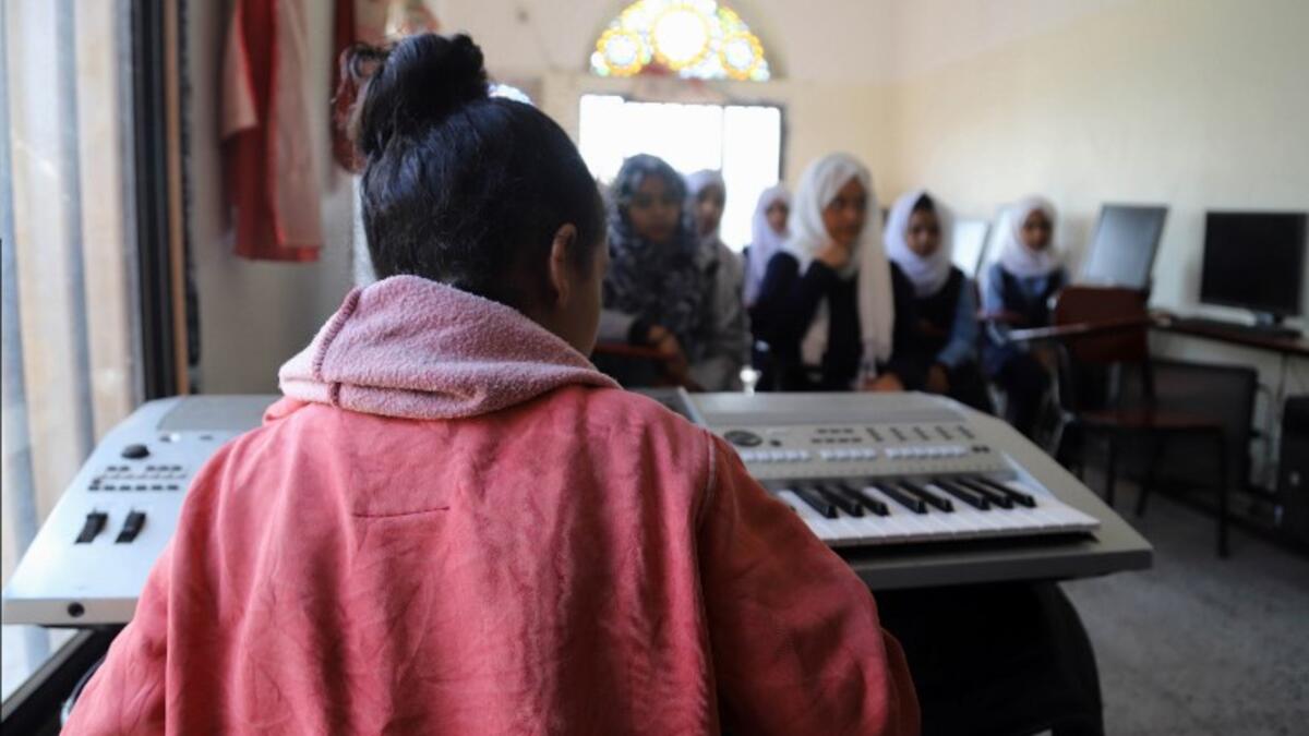 Children attend a music class at the Al-Nawras school in Taez, Yemen's third city, in the country's southwest
AHMAD AL-BASHA / AFP