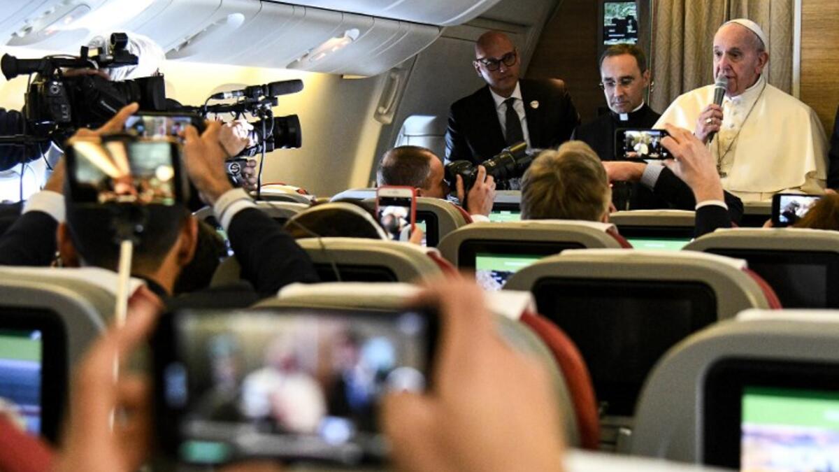 Pope Francis speaks to reporters aboard a plane on his way to Abu Dhabi on February 3, 2019. 
Vincenzo PINTO / AFP