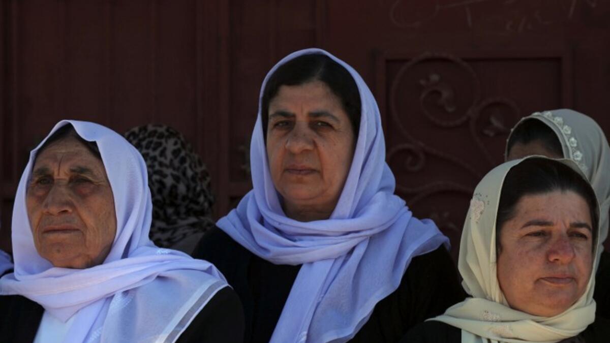Iraqi Yazidi women attend the funeral of the Mir Takhsin-Beg (Tahseen Said Ali), the hereditary leader of the Yazidi community in the world, during his funeral in the town of Sheikhan, 50km northeast of Mosul. 
SAFIN HAMED / AFP