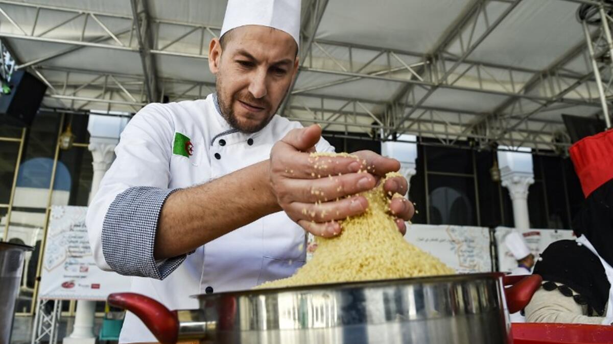 An Algerian chef prepares couscous during the 2nd edition of the International Couscous Festival at the Moufdi Zakaria Palace of Culture in  Algeria
RYAD KRAMDI / AFP