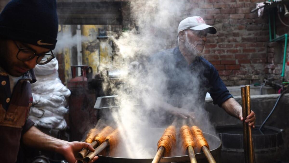 Pakistani workers dye fabric threads at a factory in Lahore 
ARIF ALI / AFP