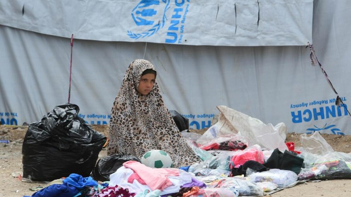 A displaced girls sells second hand items  in the souk or market of Al-Hol camp for displaced people in northeastern Syria 
GIUSEPPE CACACE / AFP