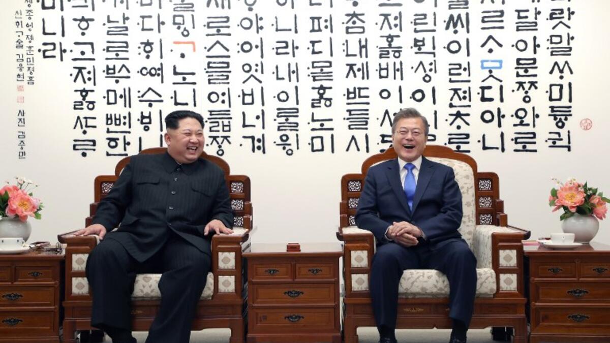 North Korea's leader Kim Jong Un (L) and South Korea's President Moon Jae-in (R)  pose for a photo during their summit in the Peace House building on the southern side of the truce village of Panmunjom on April 27, 2018. Korea Summit Press Pool / AFP
