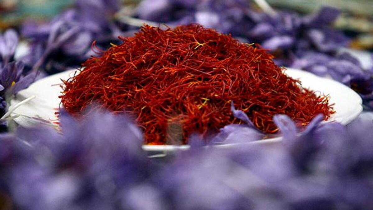 Afghan worker spreads separated saffron threads from harvested flowers at a processing centre in Herat province (Twitter)