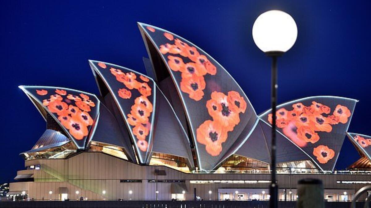 The Sydney Opera House is lit up with poppies marking the centenary of the end of World War I (AFP)