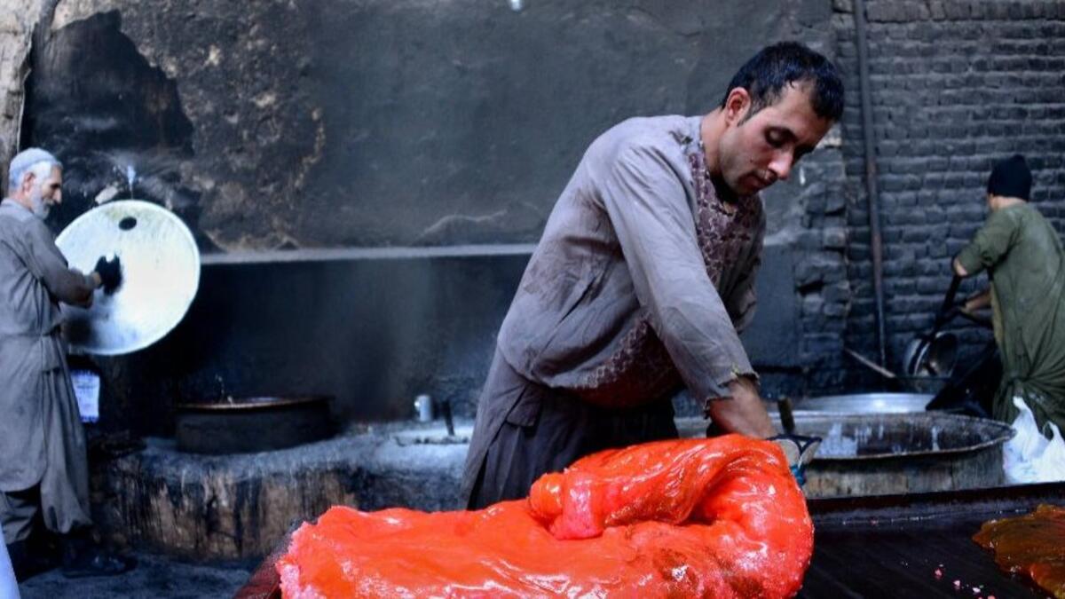 Afghan labourers work at a traditional sweet factory in Herat.
(AFP)