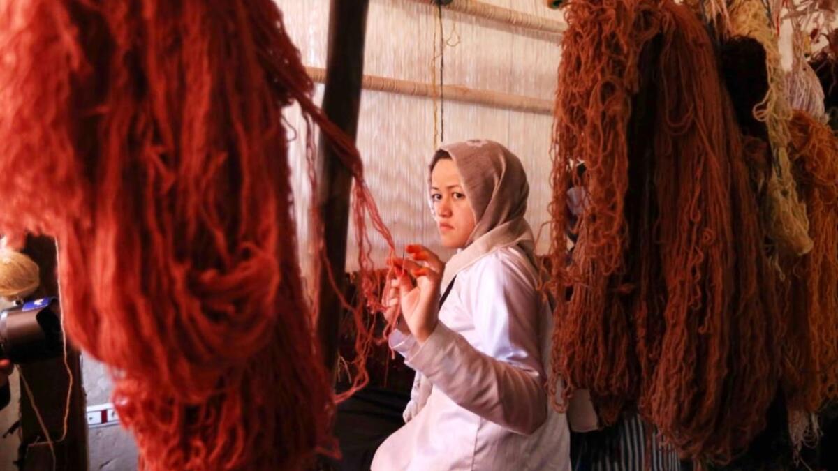 Afghan girls learn the skills to weave rugs at a small factory in the Enjil district of Herat Province (Rezayee/Twitter)