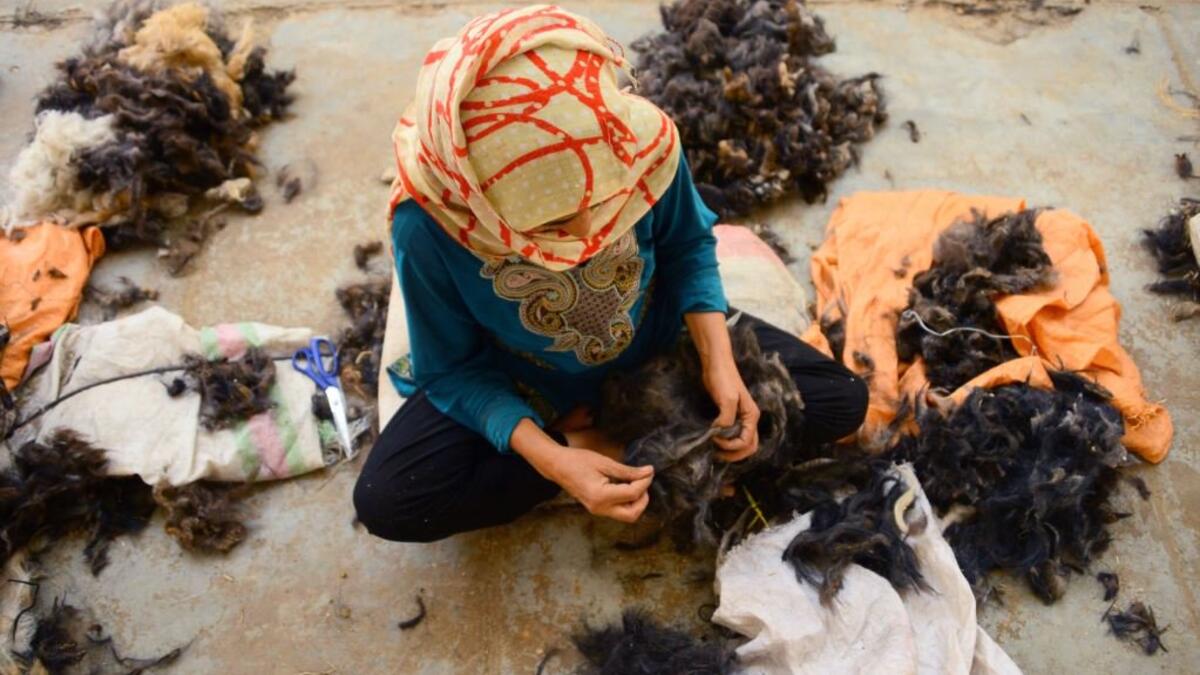 An Afghan woman works in a traditional wool factory in Herat (Twitter)