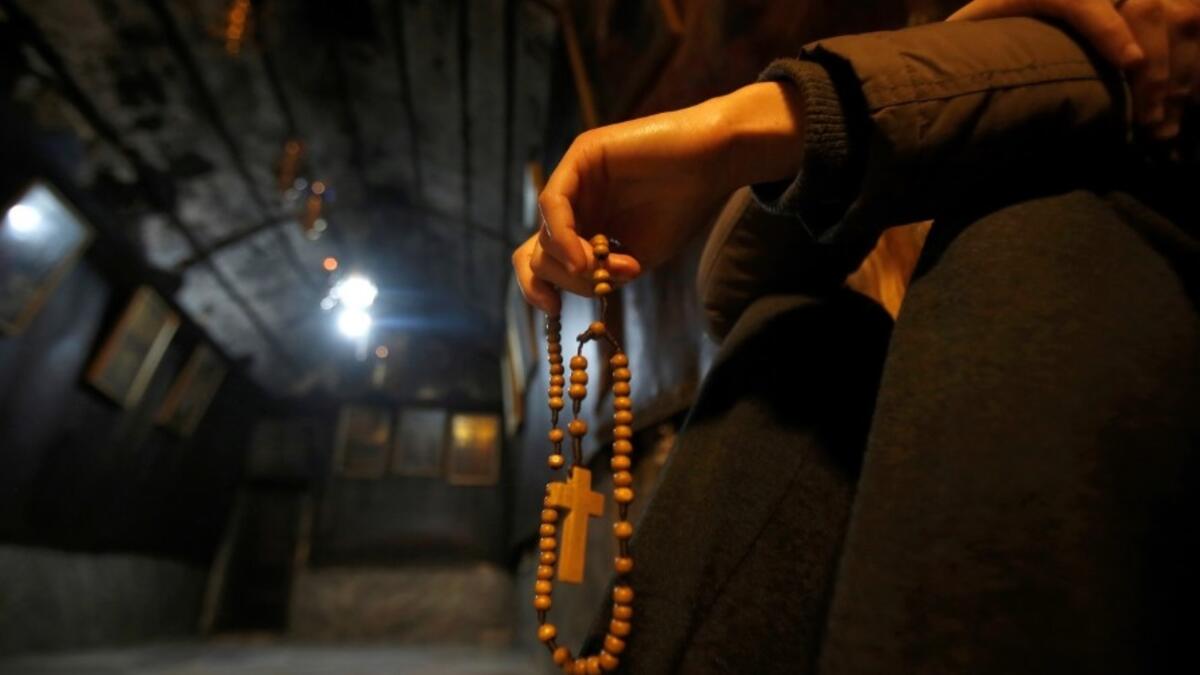 A Christian worhsipper prays inside the Grotto, believed to be the exact spot where Jesus Christ was born, at the Church of the Nativity in the biblical West Bank city of Bethlehem, on December 22, 2018, three days ahead of the Christmas celebration. 
Musa AL SHAER / AFP