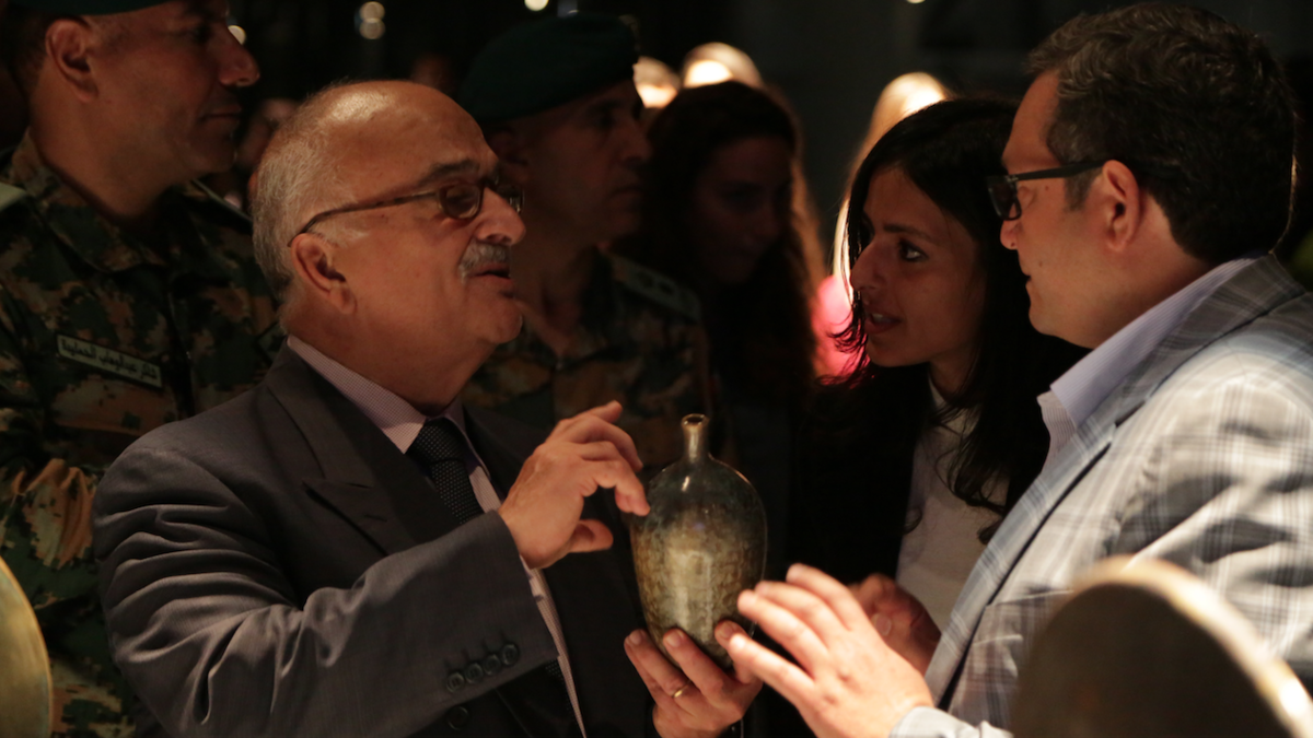 HRH Prince Hasan, the brother of the late King Hussein bin Talal of Jordan, holds a crystal-ware vase created by Aymen Azzam. (Al Bawaba/Salim Essaid)