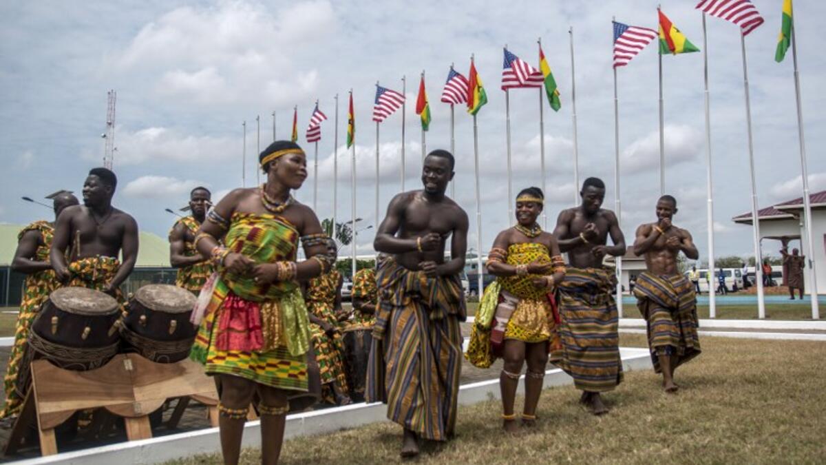 Musicians and dancers wait for the arrival of the US first lady at Kotoka International Airport in Accra on October 2, 2018. (CRISTINA ALDEHUELA / AFP)