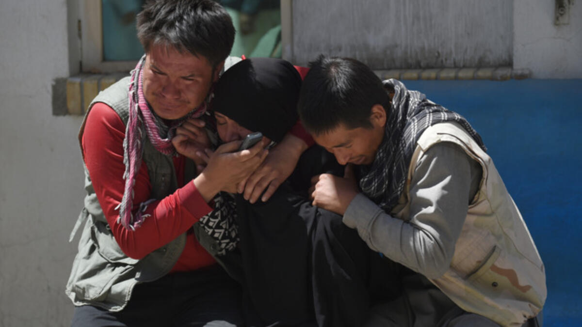 Afghan residents weeps for their relatives outside the Istiqlal Hospital in Kabul following the attack. (AFP)