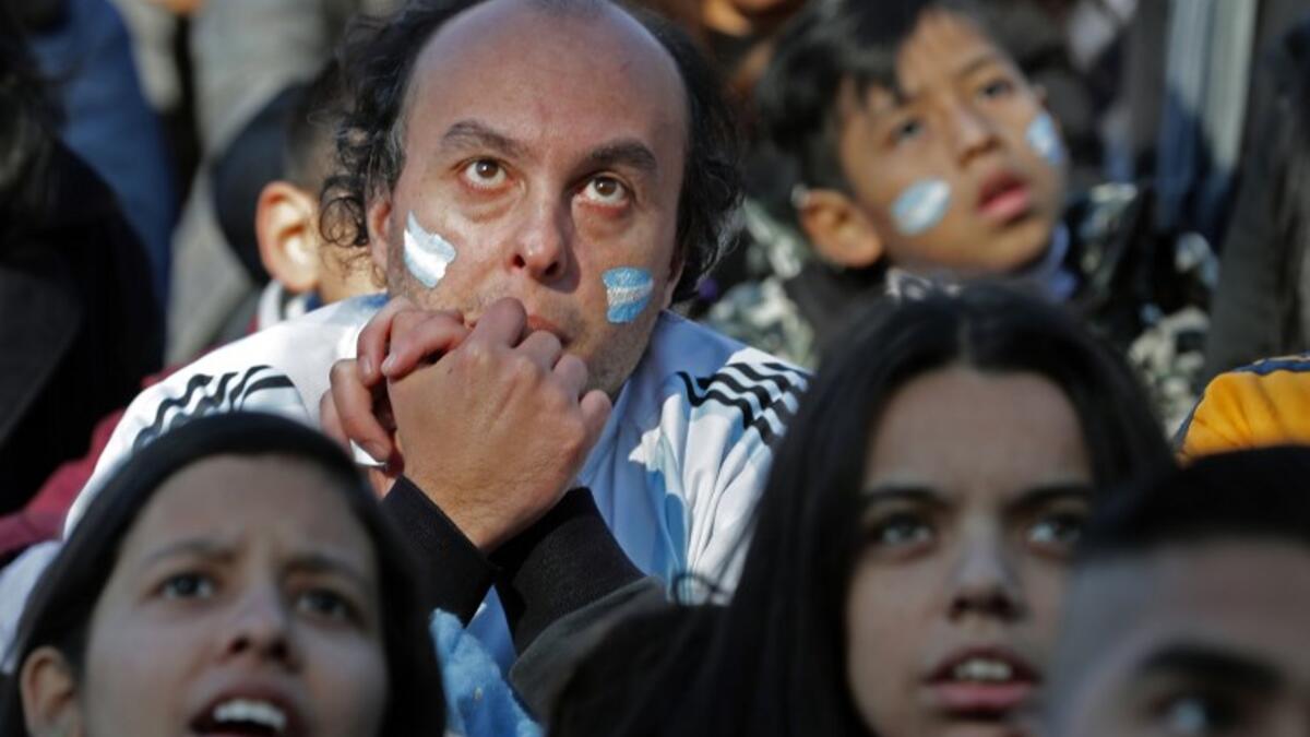 Fans of Argentina watch the FIFA World Cup Russia 2018 match between Argentina and Iceland on a large screen at San Martin square in Buenos Aires on June 16, 2018. 
ALEJANDRO PAGNI / AFP