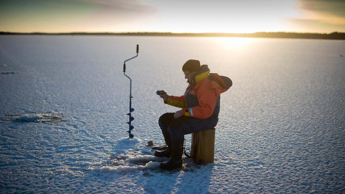 A man is ice-fishing at midday on the frozen Bothnia Sea, on December 28, 2016 in Vaasa, Western Finland. (OLIVIER MORIN/ AFP)