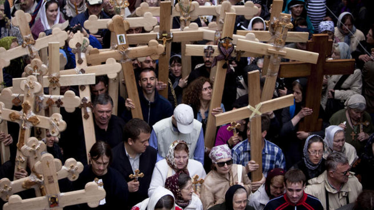 Jerusalem: Roman Catholic clergymen hold crosses as they circle around the Stone of Anointing during the Holy Thursday ceremony at the Church of the Holy Sepulchre in Jerusalem's old city.