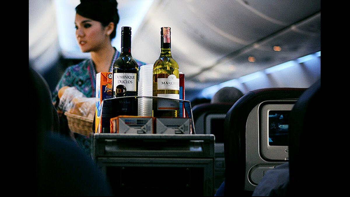 Air attendant serving drinks
