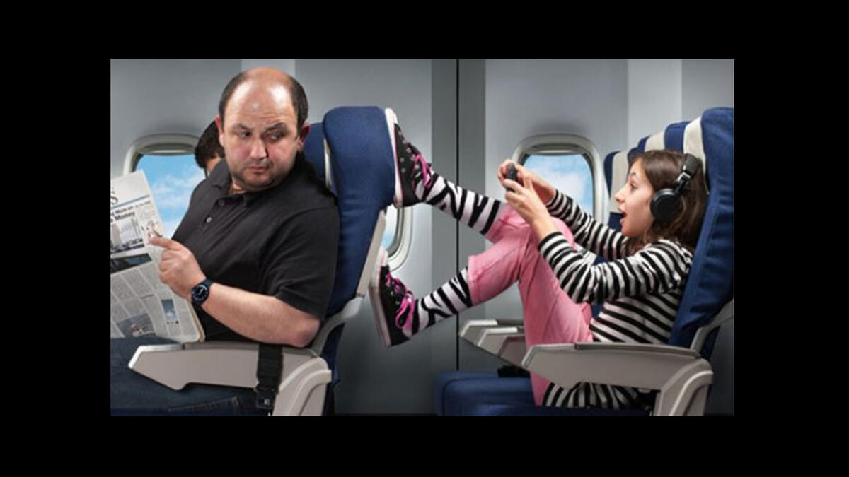 misbehaving kid kicking seat on plane