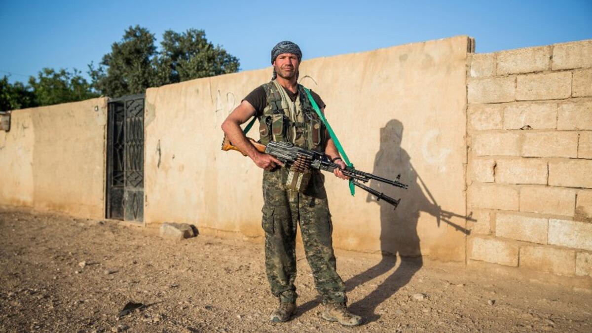 26-year-old ‘Hewal Cudi’ poses with a machine gun just outside Tal Tamr on April 19, 2015.