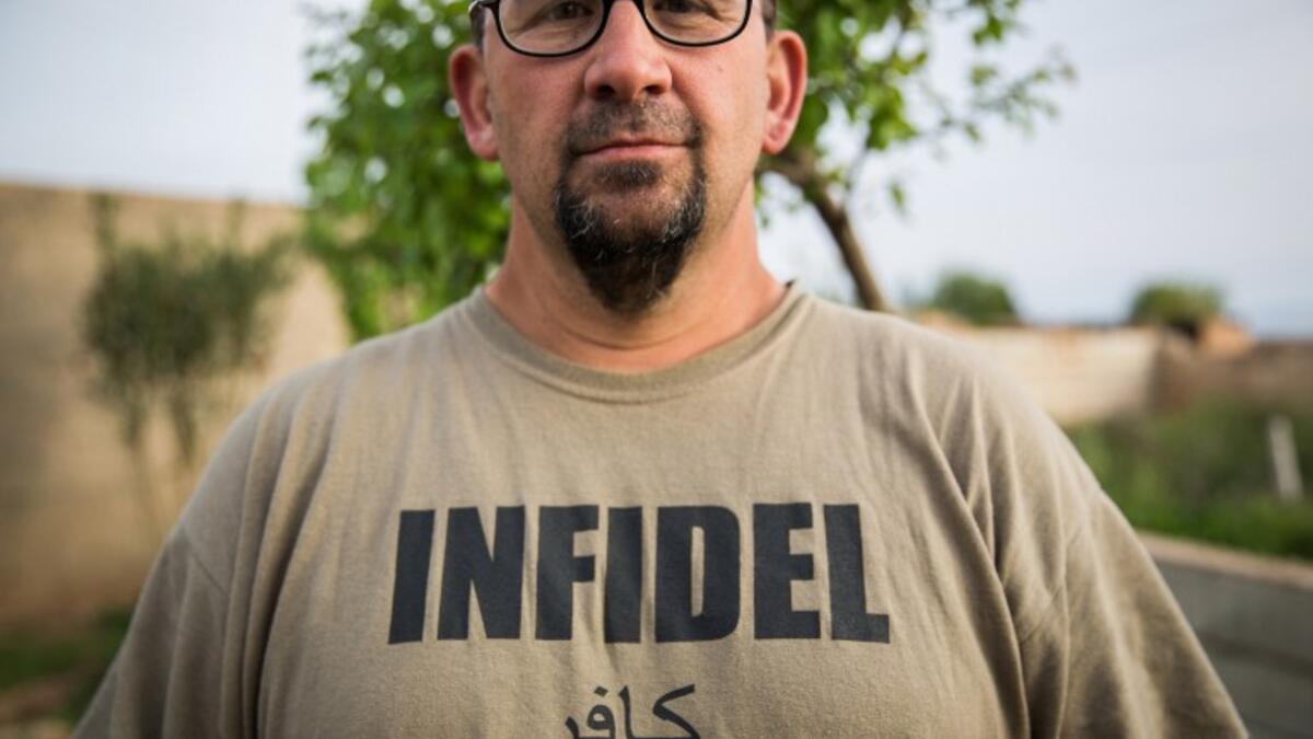 A 38-year old ex-member of the US military, nick-named ‘Hewal Cekdar,’ stands on the outskirts of Tal Tamr on April 16, 2015.