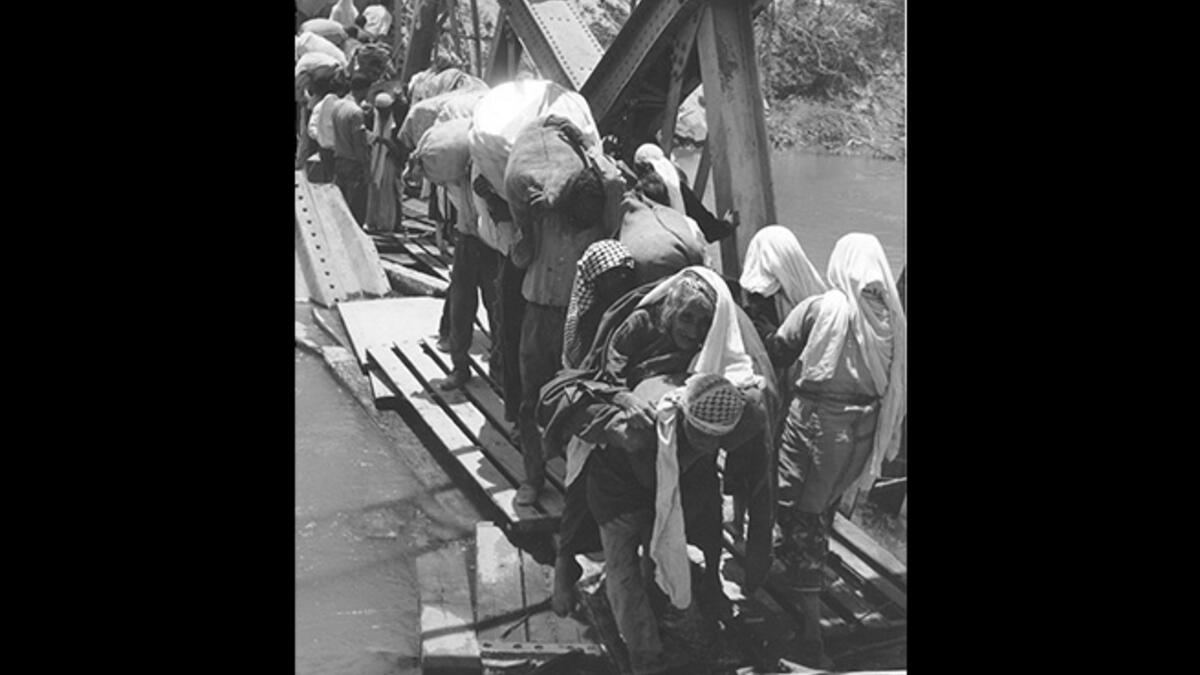 April 1948, Jordan River - Palestinians cross the Jordan River during the first Palestinian exodus known as the Nakba (catastrophe). Some 700,000 either fled or were forced out of villages during the 1948 Palestinian War, many of whom crossed into what is today Jordan. This one strikes a chord because it depicts the actual moment families left.
