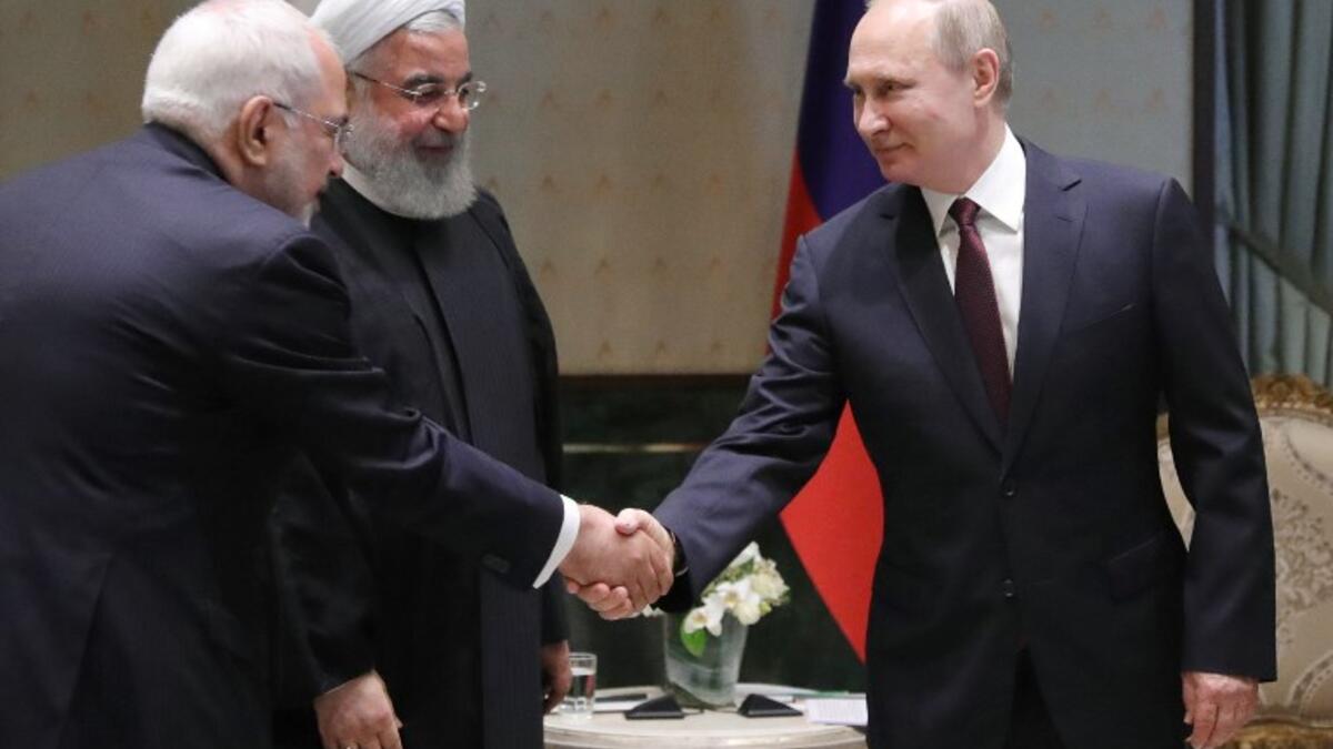 Russian President Vladimir Putin (R) shakes hands with Iranian Foreign Minister Mohammad Javad Zarif during a meeting with Iranian President Hassan Rouhani in Ankara on April 04, 2018. 
(Mikhail KLIMENTYEV /Sputnik/AFP)