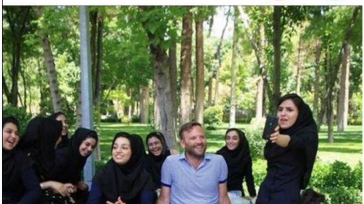 western man posing with hijabi women