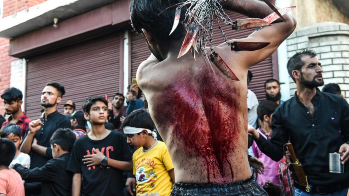 A Kashmiri Shiite Muslim mourner flagellates himself during a religious procession held on the seventh day of Ashura which remembers the slaying of the Prophet Muhammed's grandson in southern Iraq in the seventh century, in Srinagar on September 18, 2018. TAUSEEF MUSTAFA / AFP