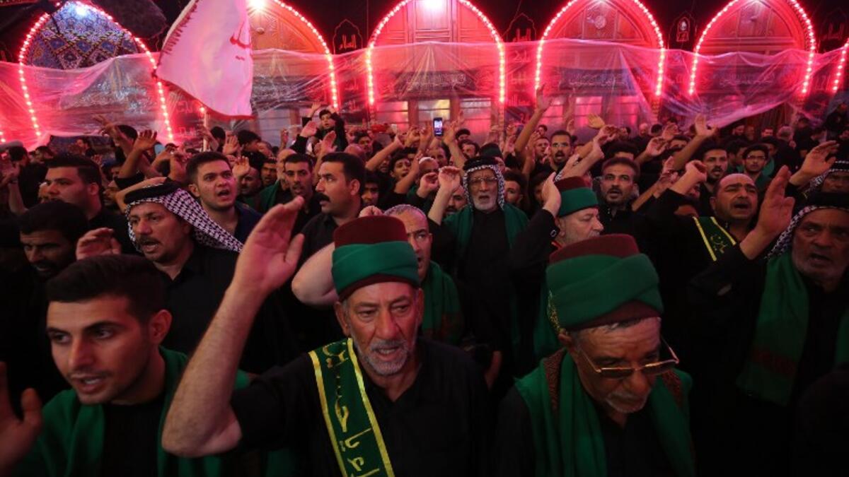 Shiite pilgrims take part in a ceremony at the Imam Hussein shrine in the southern Iraqi city of Karbala on September 19, 2018.AHMAD AL-RUBAYE / AFP