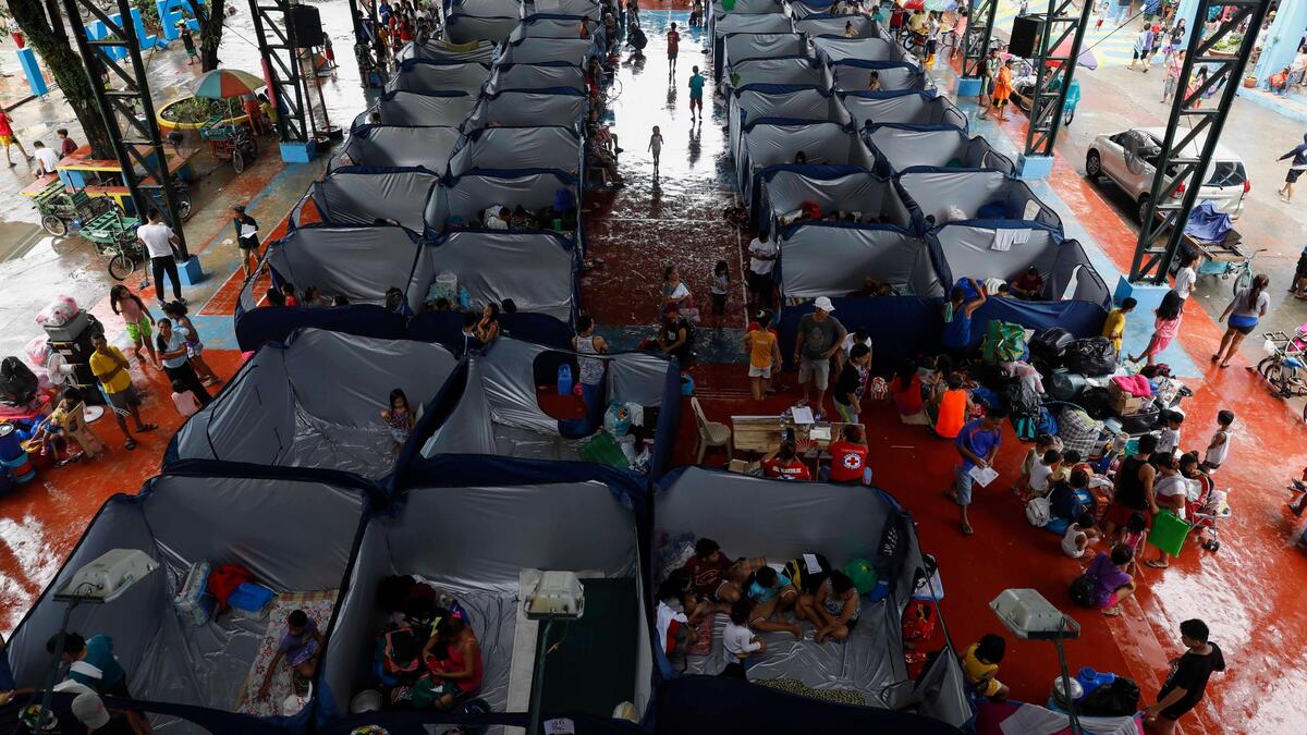 Evacuees at a temporary shelter in Marikina City, east of Manila, on Saturday. More than 100,000 have fled their homes across the Philippines (ntimes.com)