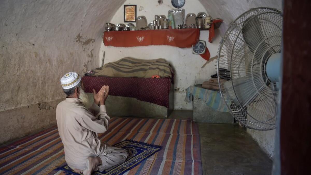 Pakistani villager Faqeer Gul offers noon prayers in his cave room in Nikko village, about 60 kilometres from the capital Islamabad.
AAMIR QURESHI / AFP