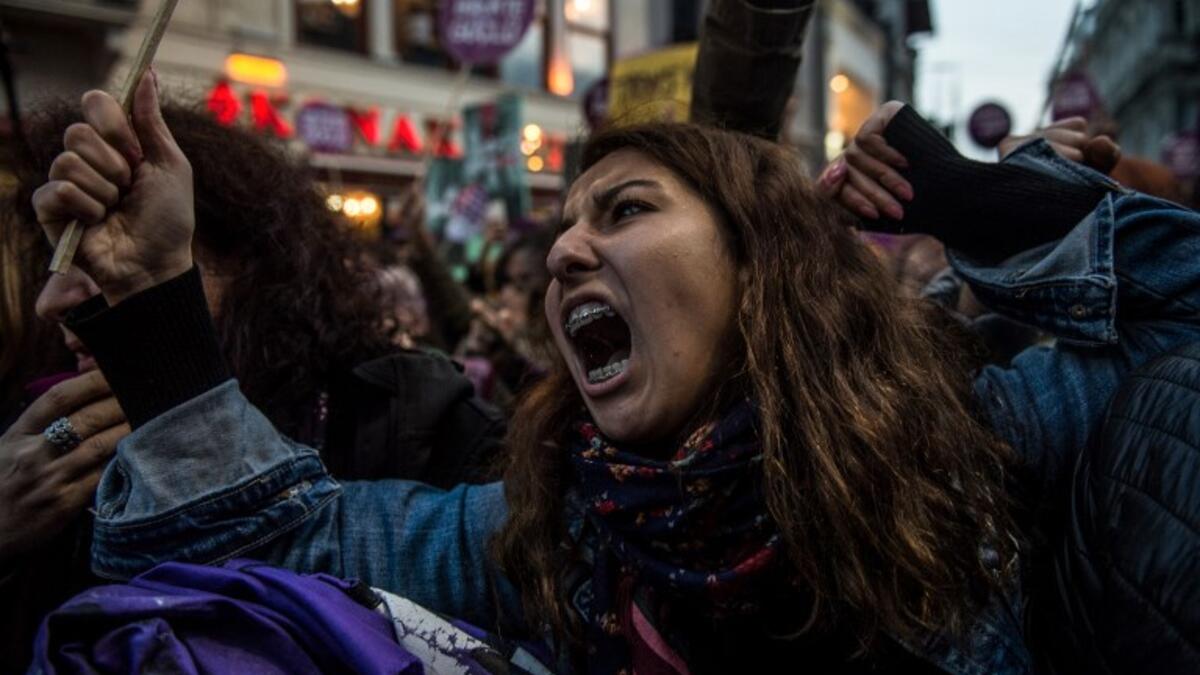 Women's rights activists react during clashes with Turkish riot police as they try to march to Taksim Square to protest against gender violence in Istanbul, on November 25, 2018, on the International Day for the Elimination of Violence against Women. 
BULENT KILIC / AFP