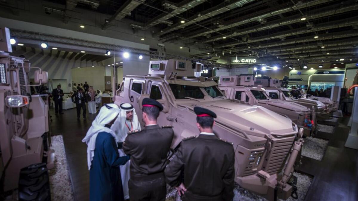 Egyptian military officers talk with Saudi men at the Saudi stand during Egypt’s first Service Defence Exhibition in Cairo on December 3, 2018, at the International Exhibition Center. 
Khaled DESOUKI / AFP
