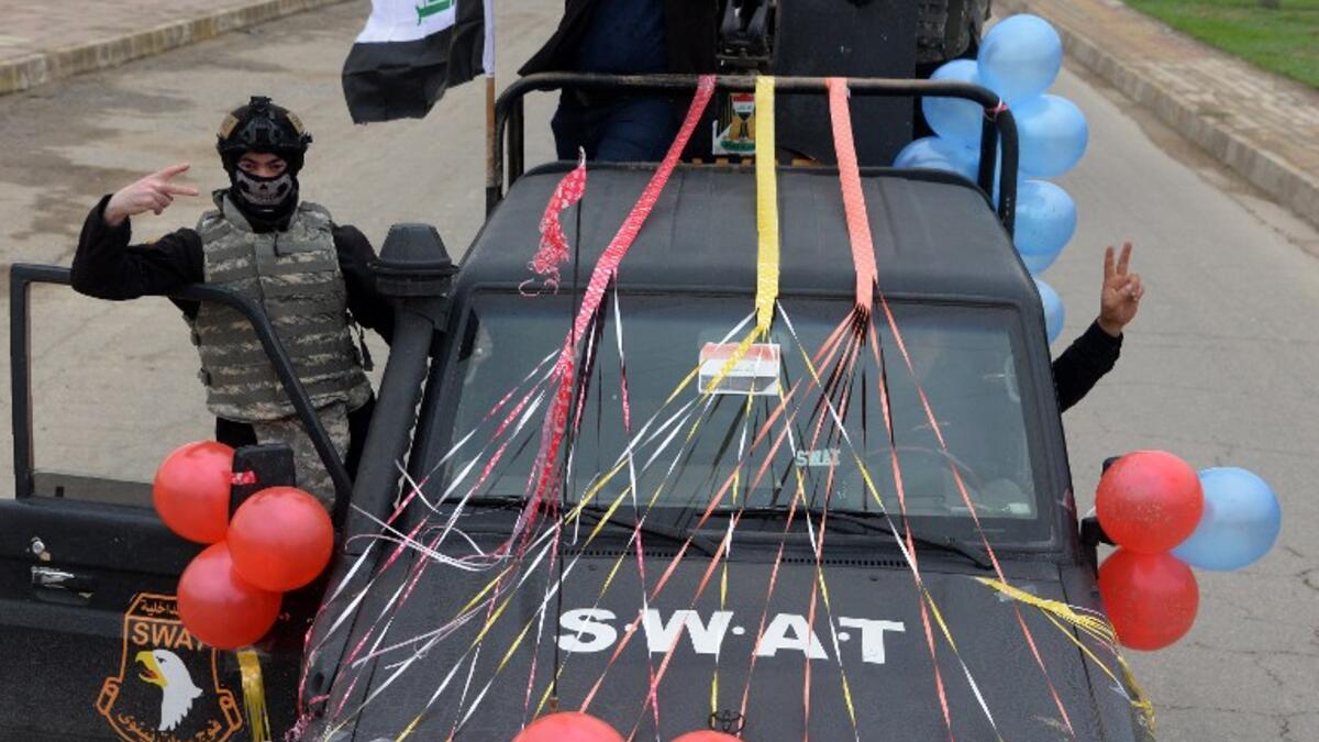Members of the Iraqi security forces parade in the streets of the Iraqi city of Mosul, during celebrations marking the first anniversary of the country's victory over the Islamic State.
Zaid AL-OBEIDI / AFP