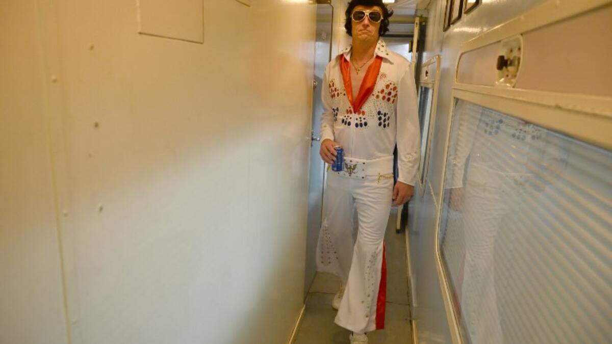 An Elvis fan walks through a train after leaving Central station to head to The Parkes Elvis Festival, in Sydney on January 10, 2019.
SAEED KHAN / AFP