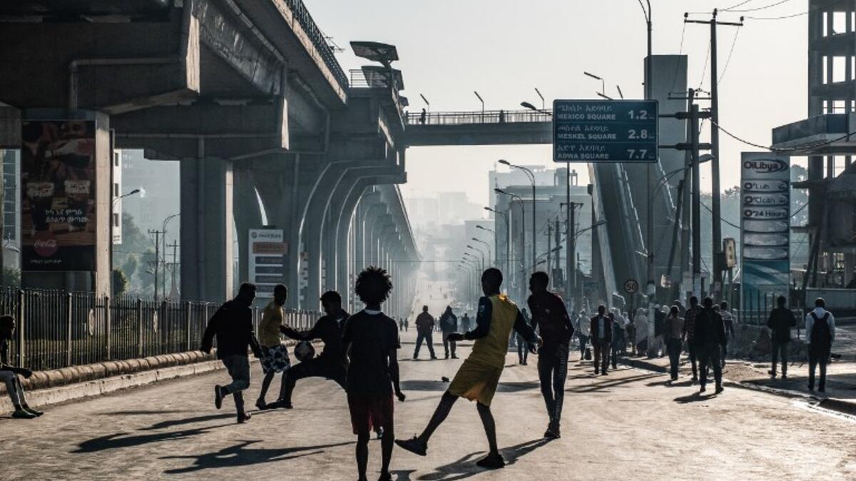 People play football on a street in Addis Ababa on February 3, 2019 during the third Car Free Day promoted by local NGOs and the Ethiopian Government to appeal a healthy life style and a less air pollution of the capital city. 
EDUARDO SOTERAS / AFP