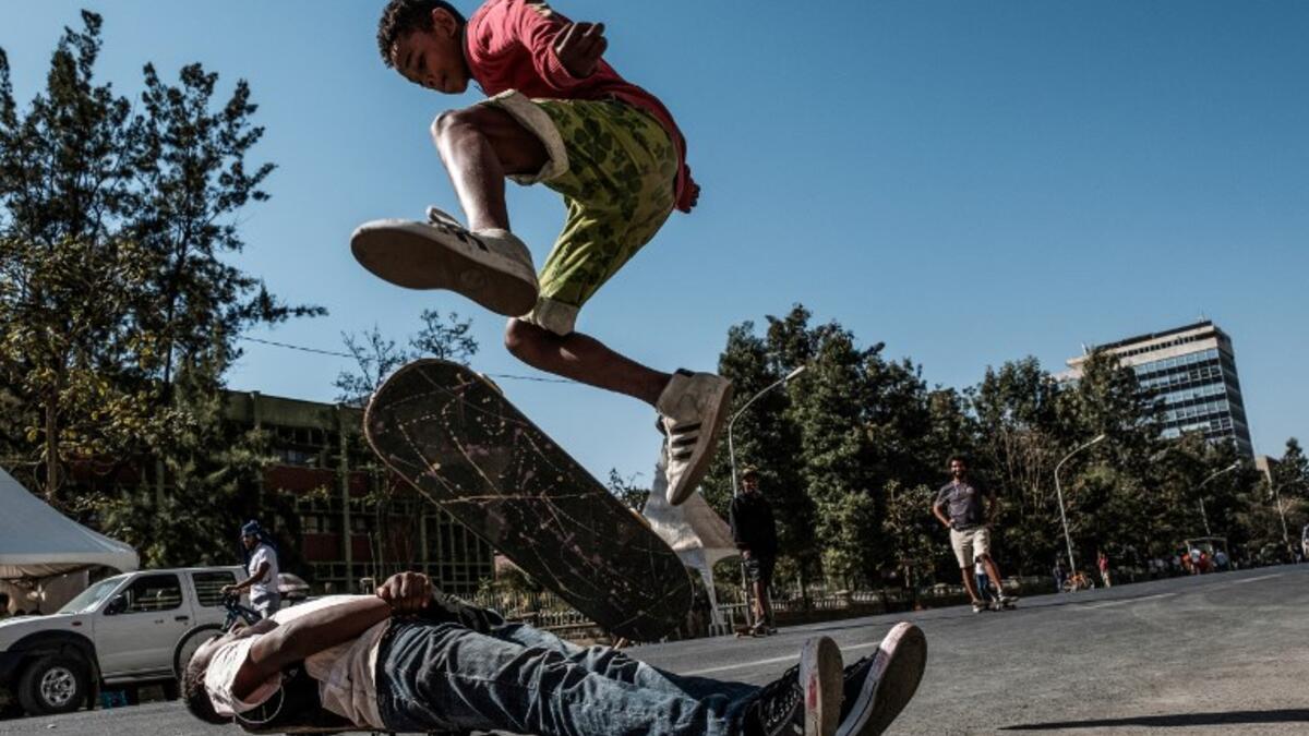 A skateboarder performs on a street in Addis Ababa on February 3, 2019 during the third Car Free Day promoted by local NGOs and the Ethiopian Government to appeal a healthy life style and a less air pollution of the capital city. 
EDUARDO SOTERAS / AFP
