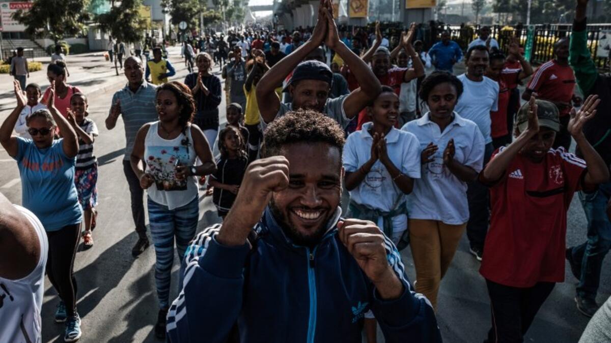 People take part in an exercise on a street in Addis Ababa on February 3, 2019 during the third Car Free Day promoted by local NGOs and the Ethiopian Government to appeal to a healthy life style and a less air pollution of the capital city. 
EDUARDO SOTERAS / AFP