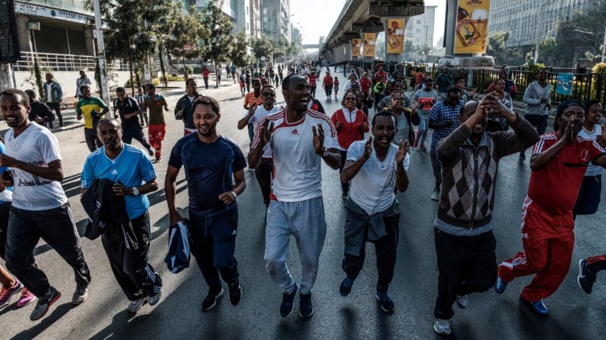 People take part in an exercise on a street in Addis Ababa on February 3, 2019 during the third Car Free Day promoted by local NGOs and the Ethiopian Government to appeal to a healthy life style and a less air pollution of the capital city. 
EDUARDO SOTERAS / AFP