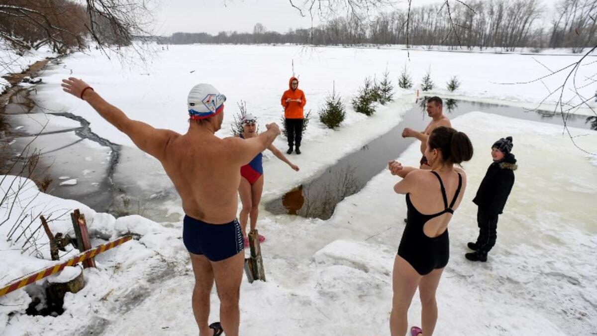 Ice swimmers warm up ahead of swimming in the icy waters of the Moscow River on February 3, 2019. 
Kirill KUDRYAVTSEV / AFP