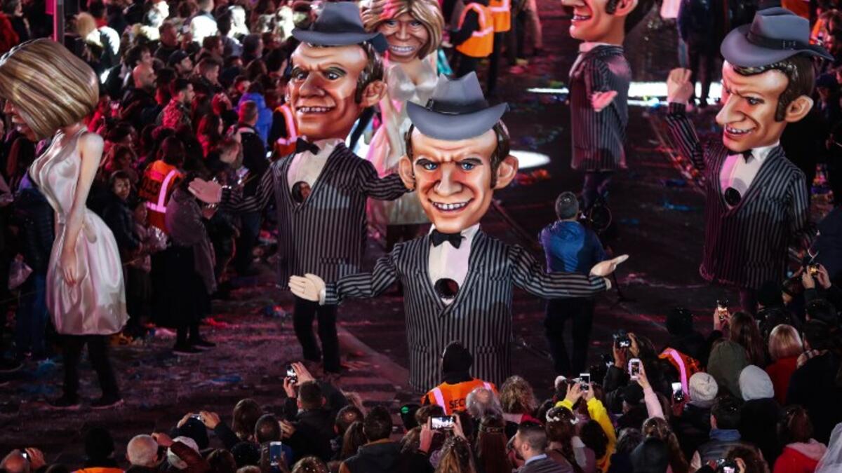 Statues of French President Emmanuel Macron and his wife Brigitte parade on the first day of the 135th Nice Carnival which runs until March 2 with the theme "King of Cinema," on February 16, 2019 in Nice, French Riviera.
VALERY HACHE / AFP
