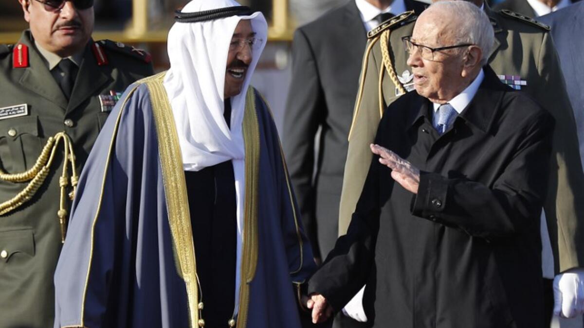 Tunisian President Beji Caid Essebsi (R) welcomes Kuwait's Emir Sheikh Sabah al-Ahmad al-Sabah upon his arrival at Tunis-Carthage international airport on March 30, 2019, to attend the Arab Summit. 
Hussein Malla / POOL / AFP