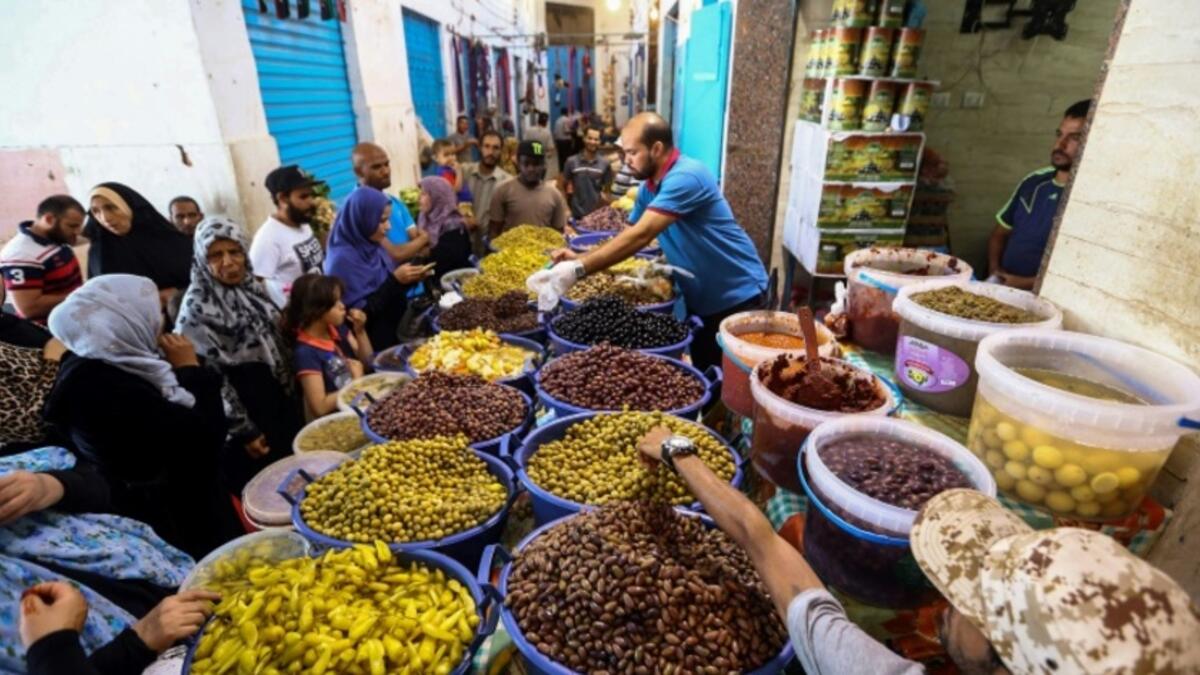 Libyans shop for olives and pickles at a market in the centre of the capital Tripoli, as the faithful prepared for the start of the Muslim holy month of Ramadan. 
AFP/MAHMUD TURKIA