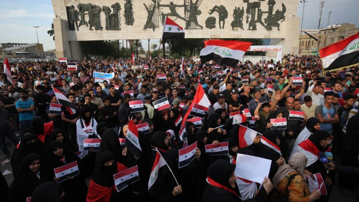 Protestors assemble on April 15 in Bagdad’s Tahir Region to denounce strikes of U.S., Britain and France against Syria. Iraqi and Syria flags are prominently hoisted Ahmad al-Rubaye / AFP