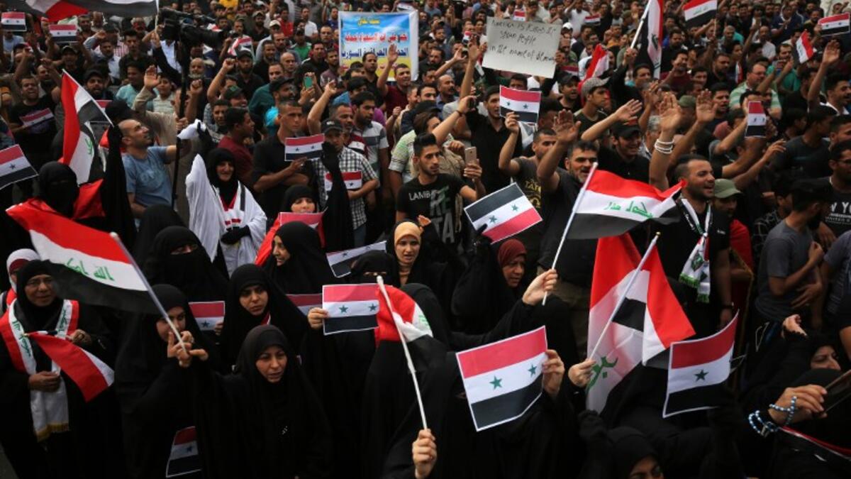 Men and women protestors in Baghdad’s Tahir Region on April 15, 2017 combine a show of unity against western military strikes on Syria for the alleged chemical attacks on Douma, AHMAD AL-RUBAYE / AFP