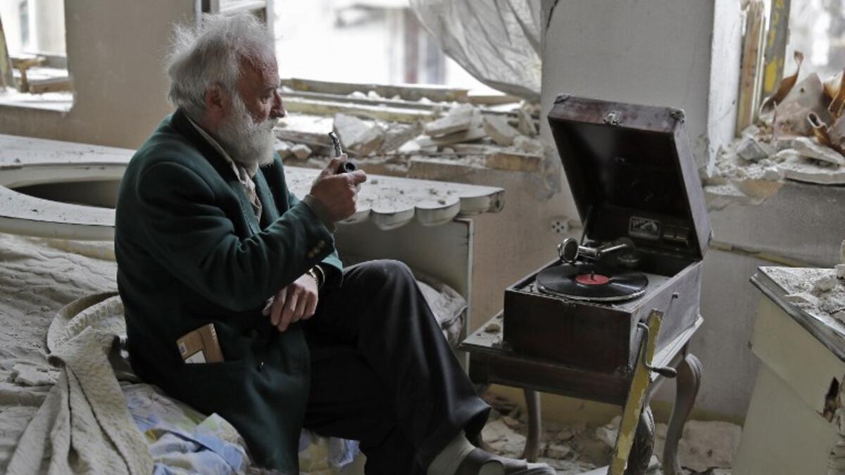 “Anis puffed on his pipe,” the AFP’s Joseph Eid wrote. “He looked out the window and he had a look on his face of a person watching a beautiful sunset. He sat there, puffing on his broken pipe and staring out the window as the music floated over the ruins of his house and the city outside.”